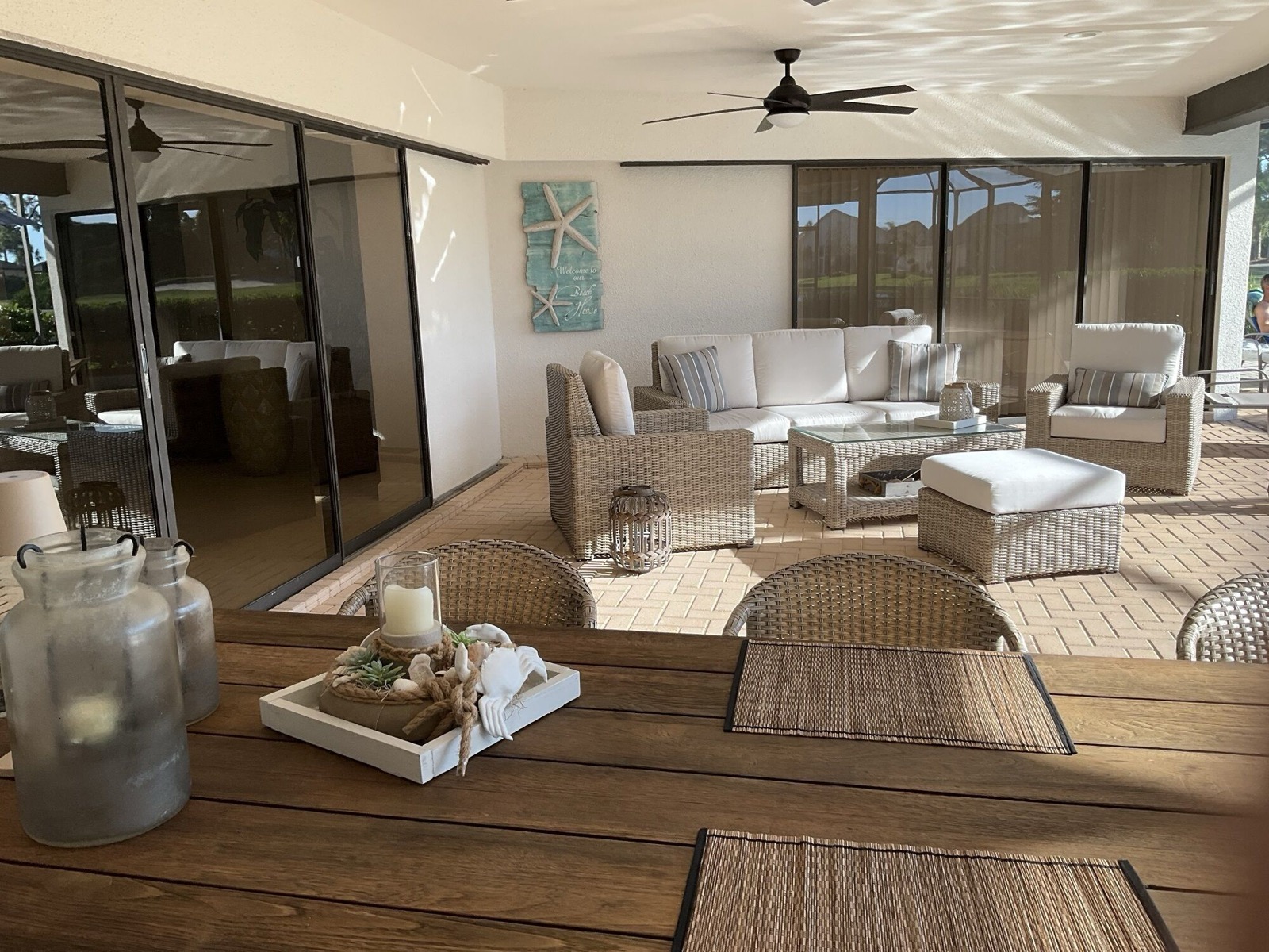 Covered lounge area on the lanai with wicker furniture