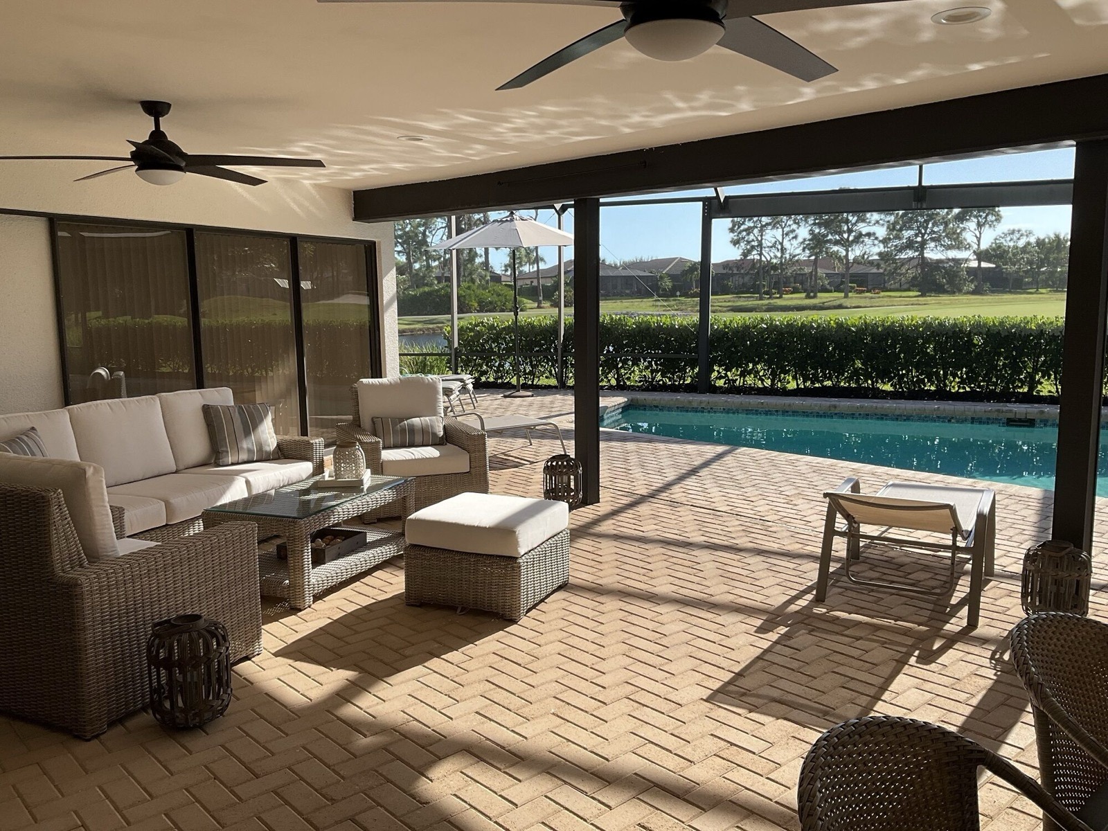 Heated pool on the screened lanai with a view over the golf course